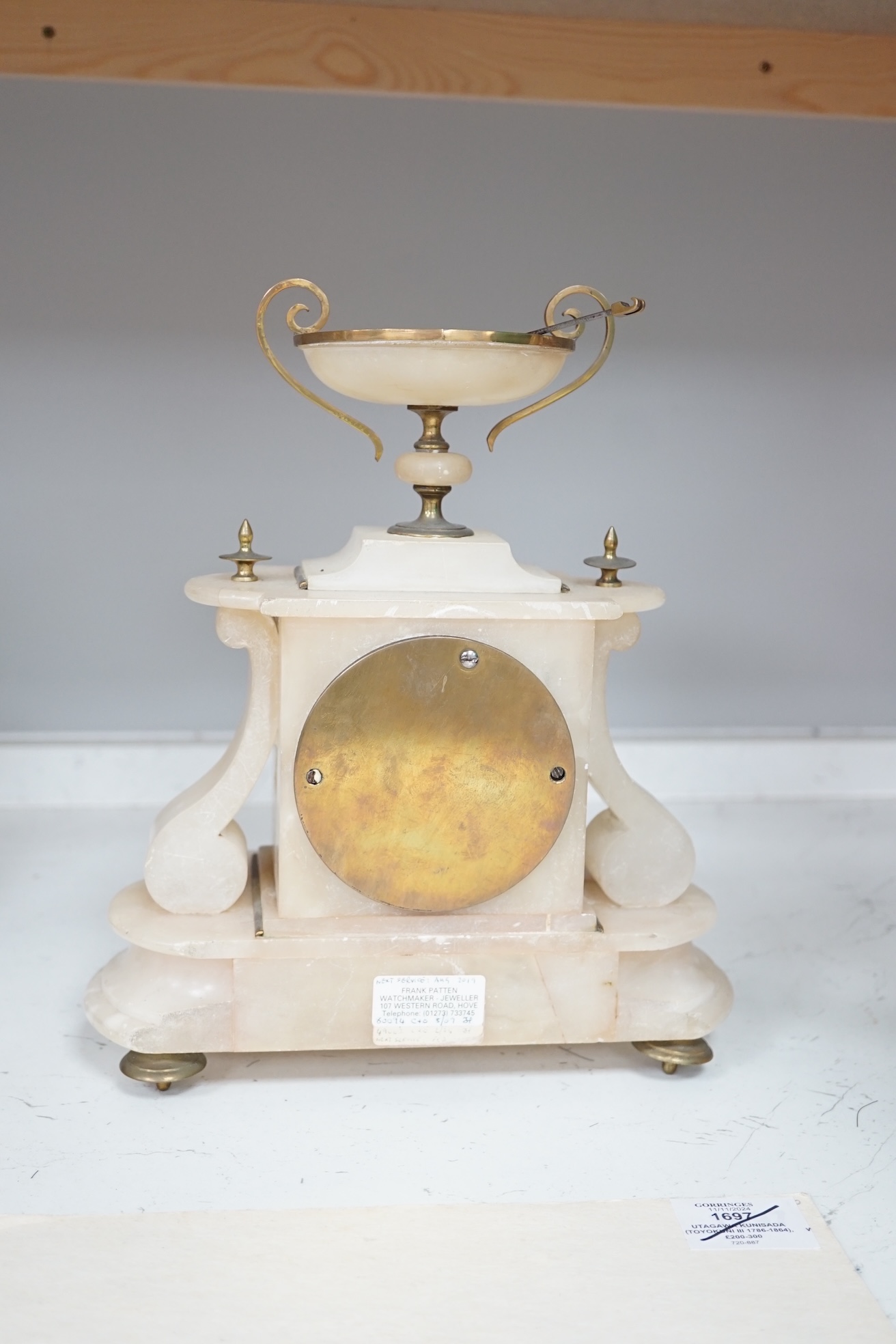 A Victorian alabaster mantel clock, striking on a bell, height 27cm. Condition - fair.